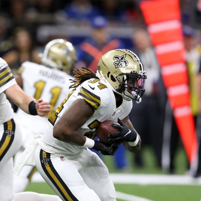 New Orleans Saints quarterback Trevor Siemian (15) hands off to New Orleans Saints running back Tony Jones Jr. (34)